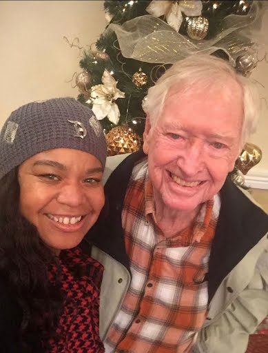 Kanika smiling with an older gentleman